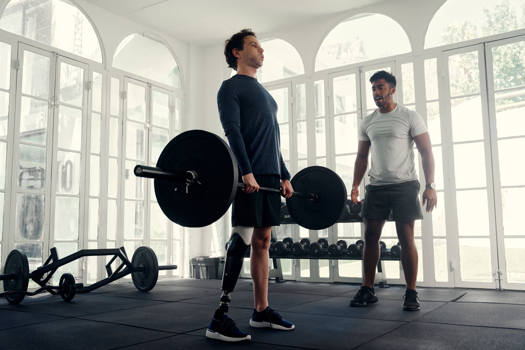 Man with prosthetic leg weight lifting